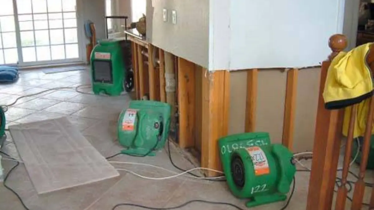 Opened wall and drying equipment in a room under repair
